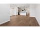 Open-concept living room with wood-look tile flooring and views into the modern kitchen at 7683 Deer Valley Circle, Tampa, FL 33635
