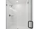 Modern walk-in shower featuring white subway tile and glass door, designed for a sleek and clean bathroom experience at 7683 Deer Valley Circle, Tampa, FL 33635