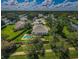 Aerial view of property showcasing a beautiful pool, lush landscaping, and expansive surroundings at 8604 Herons Cove Pl, Tampa, FL 33647
