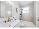 Bathroom featuring shower over tub with tiled walls, sleek vanity and gold fixtures at 8604 Herons Cove Pl, Tampa, FL 33647