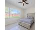 Comfortable bedroom with a large window, ceiling fan, and tile floors at 8604 Herons Cove Pl, Tampa, FL 33647