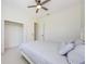 Light-filled bedroom features a ceiling fan and walk-in closet at 8604 Herons Cove Pl, Tampa, FL 33647