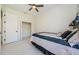 Bedroom featuring a fan, tiled floor, and walk-in closet at 8604 Herons Cove Pl, Tampa, FL 33647