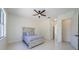 Bright bedroom features a ceiling fan, neutral paint, and an attached bathroom at 8604 Herons Cove Pl, Tampa, FL 33647