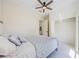Light-filled bedroom includes a ceiling fan, tiled flooring and walk-in closet at 8604 Herons Cove Pl, Tampa, FL 33647