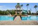 Inviting community pool with water slide and poolside lounge chairs, creating a perfect spot for relaxation and recreation at 8604 Herons Cove Pl, Tampa, FL 33647