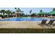 Spacious community pool with covered area and lounge chairs, perfect for relaxing and enjoying the outdoor amenities at 8604 Herons Cove Pl, Tampa, FL 33647