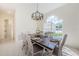 Bright dining room features a farmhouse table set with six chairs and decorative light fixture at 8604 Herons Cove Pl, Tampa, FL 33647