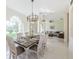 Open concept dining area with views into the living room, bathed in natural light at 8604 Herons Cove Pl, Tampa, FL 33647