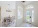 Inviting foyer area with a view of the dining room and decorative glass front door at 8604 Herons Cove Pl, Tampa, FL 33647