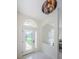 Bright foyer with a decorative glass door, white walls, and arched transom window at 8604 Herons Cove Pl, Tampa, FL 33647