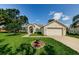 Charming single-story home featuring a well-manicured lawn and an attached two-car garage at 8604 Herons Cove Pl, Tampa, FL 33647