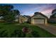 Charming single-story home featuring a well-manicured lawn and an attached two-car garage at sunset at 8604 Herons Cove Pl, Tampa, FL 33647