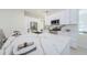 Bright kitchen features a large island with marble countertops, white cabinets, and stainless steel appliances at 8604 Herons Cove Pl, Tampa, FL 33647