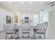 Open kitchen with seating at island, white cabinets, and stainless steel appliances, perfect for entertaining at 8604 Herons Cove Pl, Tampa, FL 33647