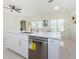 Marble countertop island with a stainless steel dishwasher and gold water tap at 8604 Herons Cove Pl, Tampa, FL 33647