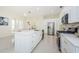 Stylish kitchen with marble counters, white cabinets, gold accents, and stainless steel appliances at 8604 Herons Cove Pl, Tampa, FL 33647