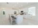 Bright, open kitchen featuring a large island, white cabinets, stainless steel appliances, and tile flooring at 8604 Herons Cove Pl, Tampa, FL 33647