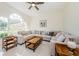 Spacious living room with large sectional sofa, wood tables, and a light and bright atmosphere at 8604 Herons Cove Pl, Tampa, FL 33647