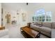 Bright living room features tile floors, neutral walls, and a large arched window at 8604 Herons Cove Pl, Tampa, FL 33647