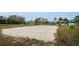 Sandy volleyball court with net and clear boundaries, close to the pool and other community amenities at 8604 Herons Cove Pl, Tampa, FL 33647