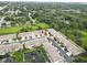 An aerial view shows the property nestled within a lush community with a pond at 8990 Antigua Dr, Seminole, FL 33777