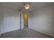 Carpeted bedroom features double closets, ceiling fan, and doorway with neutral walls at 8990 Antigua Dr, Seminole, FL 33777