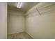 Walk-in closet with overhead shelving and neutral carpeting at 8990 Antigua Dr, Seminole, FL 33777