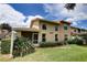A two-story building with a well-maintained lawn and landscaping at 8990 Antigua Dr, Seminole, FL 33777