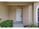 View of the front door with sidelight and plants, creating an inviting entrance to the home at 8990 Antigua Dr, Seminole, FL 33777