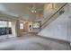 Cozy living room with staircase, ceiling fan, and sliding glass doors leading to outdoor space at 8990 Antigua Dr, Seminole, FL 33777