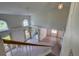 Spacious living room featuring vaulted ceilings, large windows, and a staircase at 8990 Antigua Dr, Seminole, FL 33777