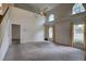 Bright living room with high ceilings, large windows, neutral carpet, and open floor plan at 8990 Antigua Dr, Seminole, FL 33777