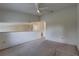 This open loft area is carpeted and features a ceiling fan at 8990 Antigua Dr, Seminole, FL 33777