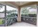 An enclosed screened porch offers a serene view of surrounding greenery at 8990 Antigua Dr, Seminole, FL 33777