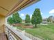 View from a balcony featuring white railings overlooking the lawn and trees at 22706 Gage Loop # 31, Land O Lakes, FL 34639