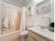 A bathroom with a toilet, sink, tub, and white shower curtain at 22706 Gage Loop # 31, Land O Lakes, FL 34639