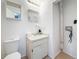 A half-bathroom with a single sink, toilet, and exposed plumbing at 22706 Gage Loop # 31, Land O Lakes, FL 34639
