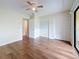 Bright bedroom featuring hardwood floors, ceiling fan, closet and sliding glass doors to a balcony at 22706 Gage Loop # 31, Land O Lakes, FL 34639