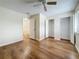 Bedroom with wood floors, a ceiling fan, and closets at 22706 Gage Loop # 31, Land O Lakes, FL 34639