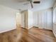 Bedroom featuring wood floors, a ceiling fan, and double closets at 22706 Gage Loop # 31, Land O Lakes, FL 34639