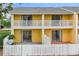 Yellow exterior featuring white fences and balconies at 22706 Gage Loop # 31, Land O Lakes, FL 34639