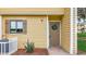 Close-up of a condo entrance featuring a wreath-adorned door, neat landscaping, and a well-maintained exterior at 22706 Gage Loop # 31, Land O Lakes, FL 34639
