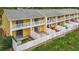 Aerial view of the yellow exterior featuring white fences and balconies at 22706 Gage Loop # 31, Land O Lakes, FL 34639