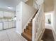 Bright interior featuring a staircase, neutral walls, and easy access to the kitchen and living areas at 22706 Gage Loop # 31, Land O Lakes, FL 34639