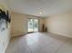 Bright living room with sliding glass doors and neutral walls, offering natural light and access to outdoor space at 22706 Gage Loop # 31, Land O Lakes, FL 34639