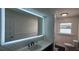 Bathroom vanity features an illuminated mirror and stylish tiling at 1027 Fountainhead Dr, Largo, FL 33770