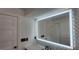 Bathroom vanity features an illuminated mirror and stylish tiling at 1027 Fountainhead Dr, Largo, FL 33770