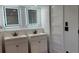Dual sink bathroom with modern lighting at 1027 Fountainhead Dr, Largo, FL 33770