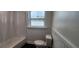 Clean bathroom featuring a tub with shower, tiled floor, and window at 1027 Fountainhead Dr, Largo, FL 33770